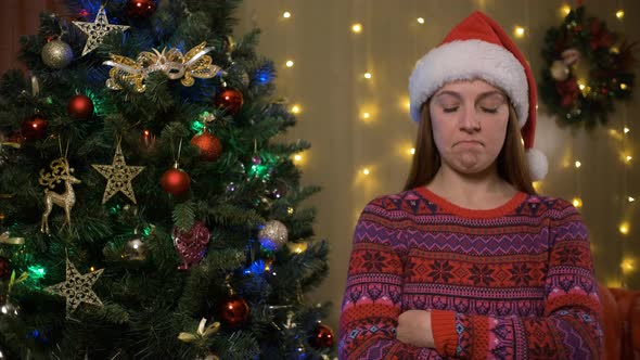Young Sad Woman in Christmas Santa Hat