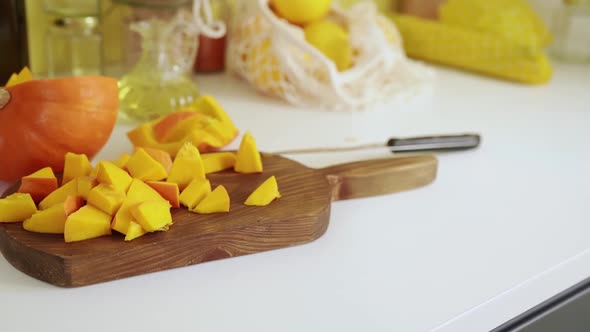 Close Up of Chopped Pumpking on Cutting Board alt