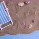 Sun Lounger and Seashells on the Sand on a Blue Background - VideoHive Item for Sale