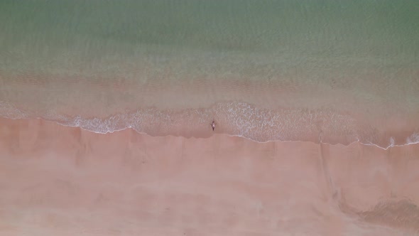 Woman In Bikini Lying In Shallow Tide On Nacpan Beach alt