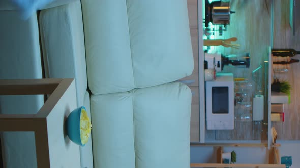 Vertical Video: Lady Resting with Snaks Watching a Movie alt