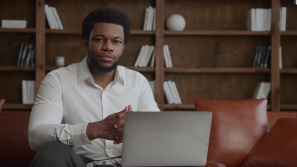 Portrait of an Africanamerican Businessman in Front of His Laptop alt