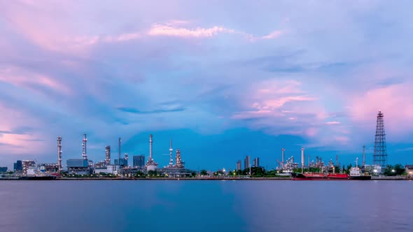 Oil refinery petrochemical and energy industry, day to night, zoom out - Time-lapse