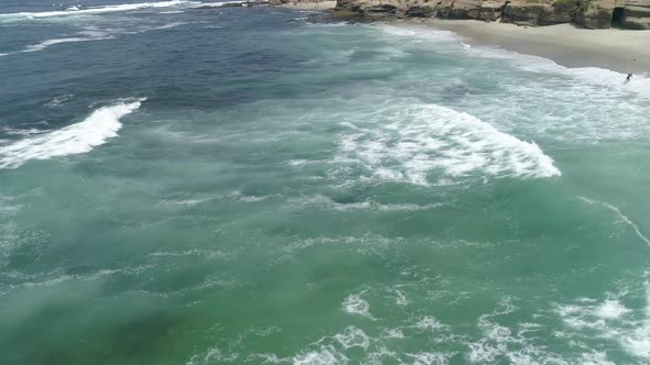 Aerial view of waves reaching the coast alt