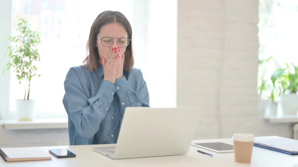 Young Woman Working on Laptop and having Coughing alt
