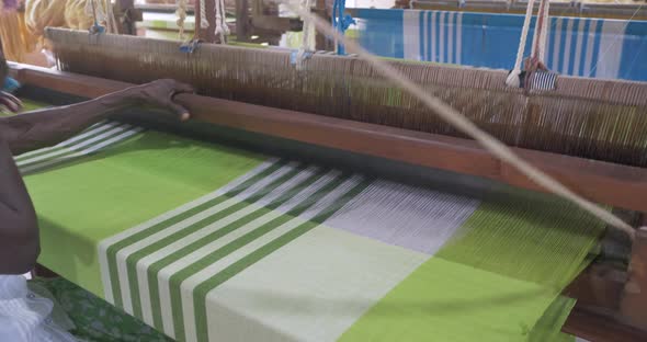 A Footage of a Woman Using Loom in a Traditional Asaian Factory