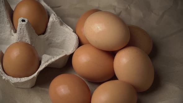 Woman's Hand Takes a Chicken Egg From a Container alt