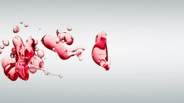 Transparent Cosmetic Red Oil Bubbles and Shapes on White Background for Vertical Video
