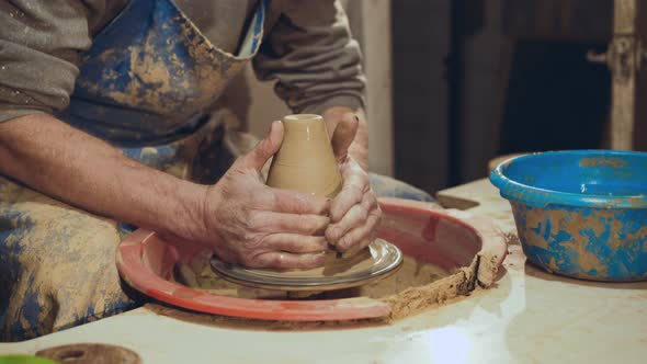 Potter Hands Making Clay on Potter's Wheel alt