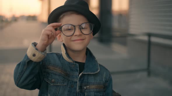 Smart Boy with Glasses. Portrait of Happy Smart Kid Model Looking To the Camera and Smiling alt