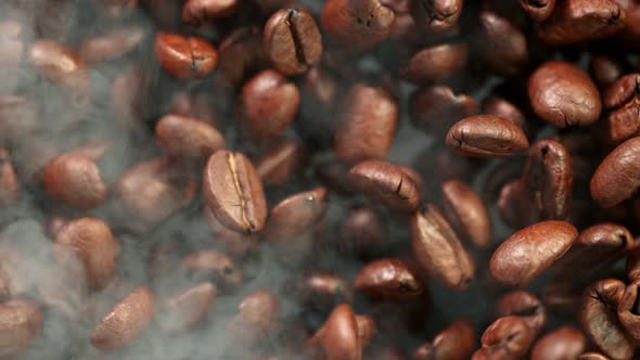 Super Slow Motion Detail Shot of Coffee Beans and Smoke Background at 1000Fps alt