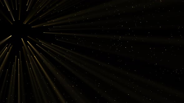 Abstract movement of golden particles emitted by rays and shimmering.