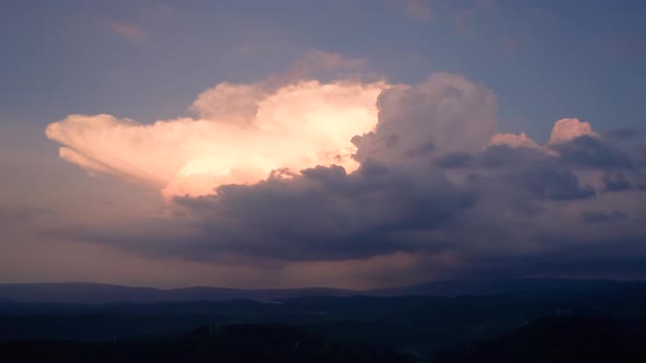 Aerial time lapse of developing thunderstorm at sunset