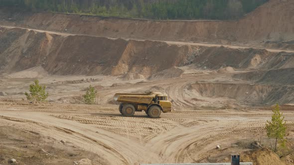 Big Dump Truck Carries the Sand in the Ballast Quarry alt