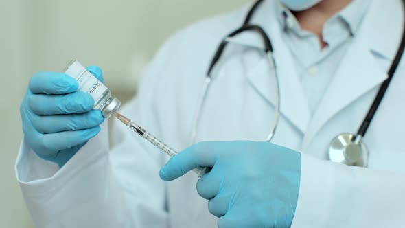 Coronavirus Vaccination Vial Being Used By Scientist or Doctor Wiht Injection Needle