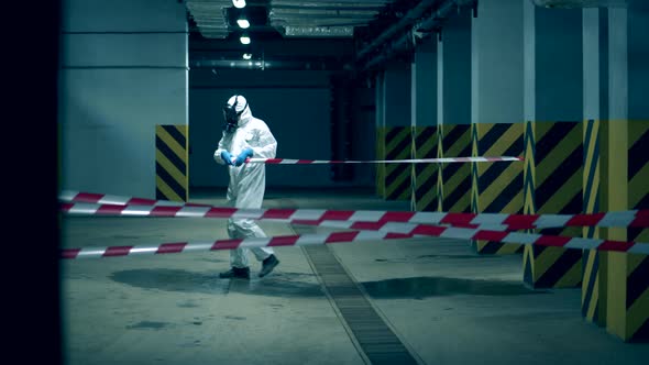 One Person Uses Tape While Restricting a Zone During Pandemic. Coronavirus Prevention, Covid-19 alt