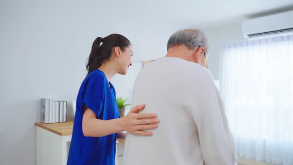 Asian senior elderly man patient doing physical therapy with caregiver. alt
