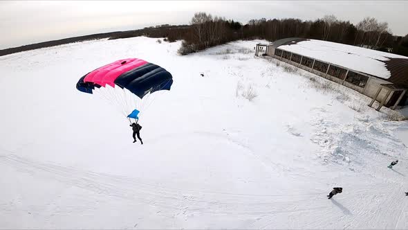 A Ramair Parachute Flying Over a Winter Field