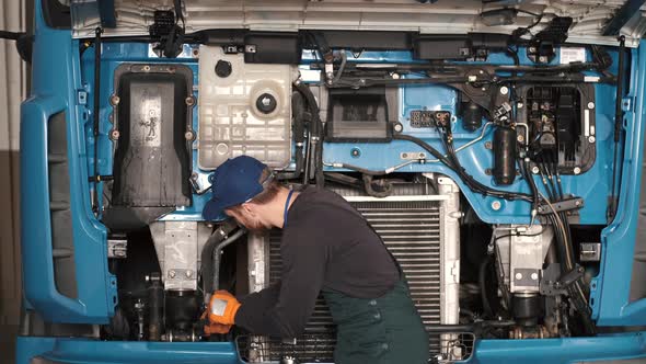 Professional Car Mechanic Check Trucl Engine in Car Garage alt