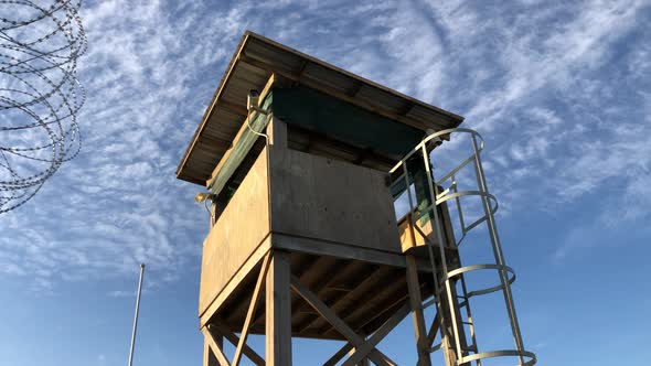 concept shot of wooden military watchtower on low angle against blue sky environment with white cirr alt