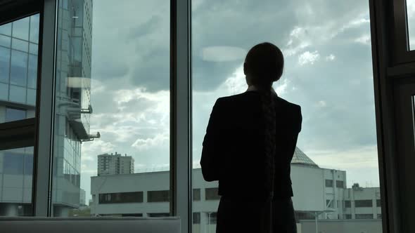 Girl Comes To the Window, the Silhouette of a Girl