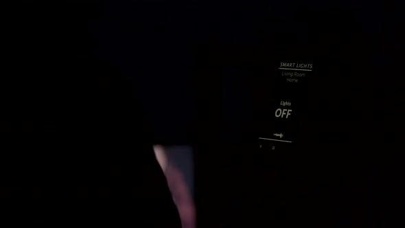 Close Up of Man Using a Voice Activated Application To Turn on the Lights in the House alt