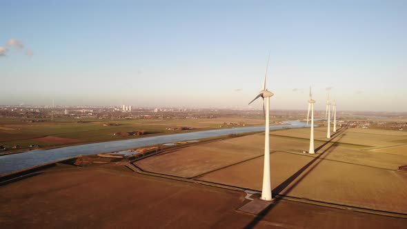 Aerial view reveals wind turbines. Alternative electric generators, green energy alt