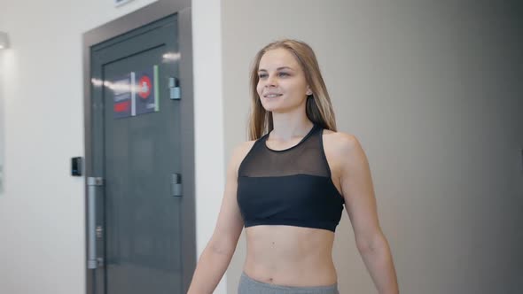 Girl Walking Inside Hall at Modern and New Gym Center