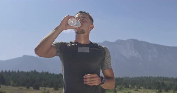 Slow Motion Shot of Sporty Woman Drinking Water and Resting From Exercise alt