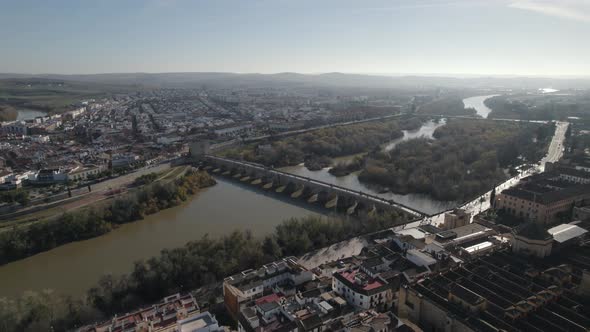 Aerial view cityscape of Cordoba with Roman Bridge over the Guadalquivir River, Bright Sunlight
