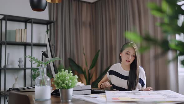 young adult asian female working at home tele conference meeting