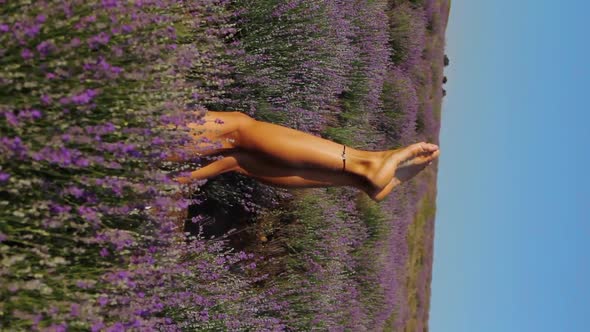 Woman Legs Sticking Out of the Purple Lavender Bushes