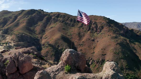 Red Blue and White Striped Flag Is Fluttering on Wind in Scenic Green Mountains alt