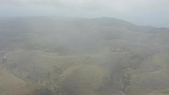 Panoramic Shot of Lush Hills in Bali, Indonesia Revealed Behind Foggy Sky alt