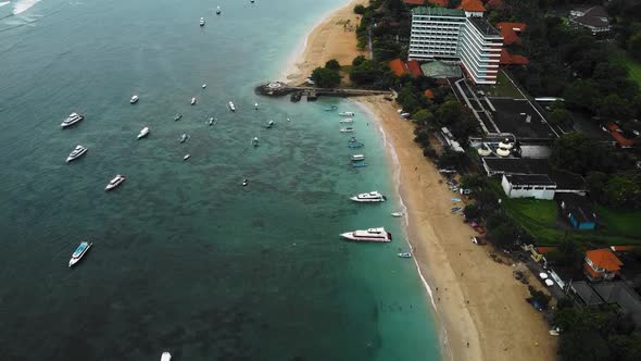 Beautiful cinematic Sanur beach, Bali drone footage with interesting landscape, fishing boats, hotel alt