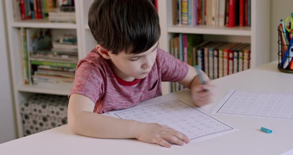 School Boy Learning to Write Numbers With Left Hand