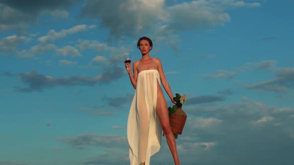 Wine Manufacturing. Sexy Sensual Young Woman with Glass of Red Wine. Woman Sommelier Is Tasting Wine alt