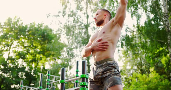 Sporty Man Doing Some Warmup Activity Outdoor in Sunny Morning alt