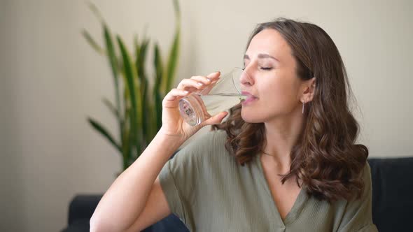 Beautiful Young Woman Drinking Pure Fresh Water alt