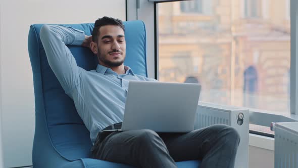 Young Arabic Professional Working on Laptop Dreaming Create New Idea alt