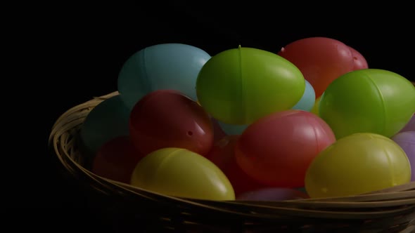 Rotating shot of Easter decorations and candy in colorful Easter grass  alt