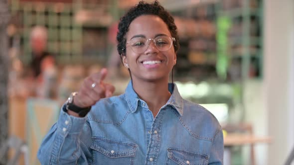 Portrait of Cheerful African Woman with Pointing with Finger alt