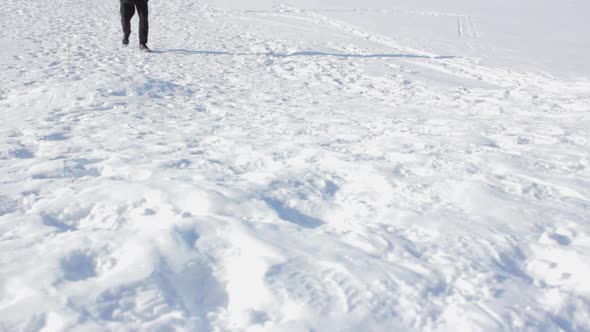 A Man Walks in the Snow in Winter