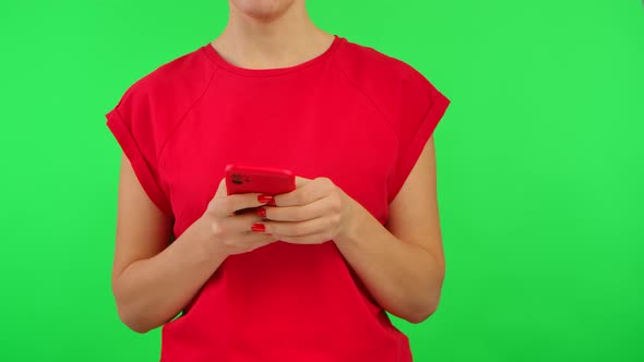 Woman in Red Tshirt Texting on Smartphone and Demonstrates Phone with Workspace Mock Up Screen on alt