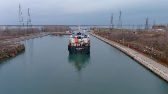 4K aerial footage of a cargo ship crossing the Beauharnois Canal in the St Lawrence Seaway, Canada.