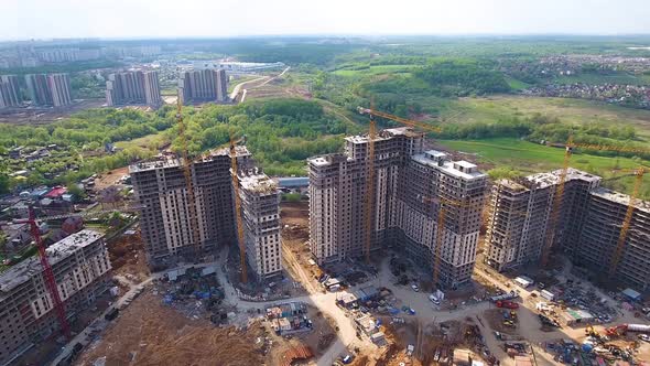 Drone flies over a construction site near Moscow. Construction cranes in the industrial zone. 