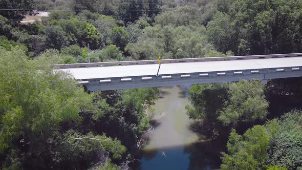 Barn swallows fly around the camera as the drone flies towards a bridge over the San Antonio river i alt