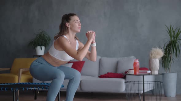 Woman in Sportswear Doing Squats, Standing Sideways To the Camera
