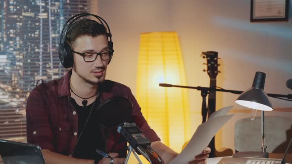 Closeup of the Radio News Reporter Presenting News Stories and Events Happening in the World alt