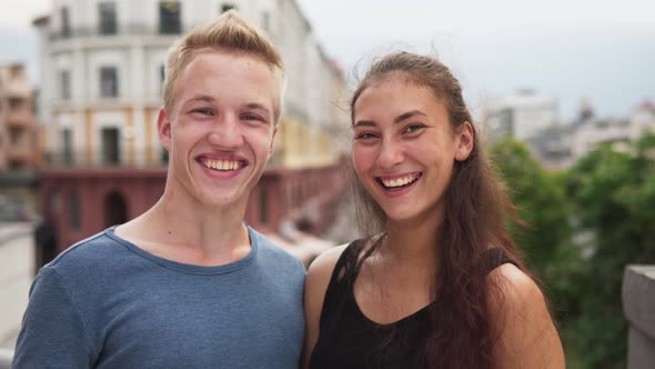Happy Mixed Race Guy and Girl Smiling at Urban Street on Summer